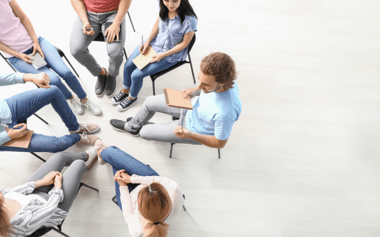 image of 7 people in a group therapy 